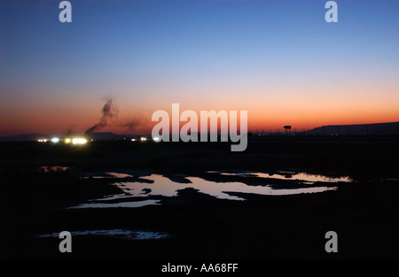 The surreal landscape of Azerbaijan is shown at sunset near an oil field in the Caspian Sea outside of Baku Azerbaijan in Stock Photo