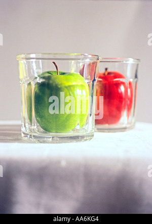 "red apple "green apple" in "^drinking ^glasses", focus on green" Stock Photo