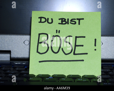 memo note on notebook Du bist böse you are mean Stock Photo