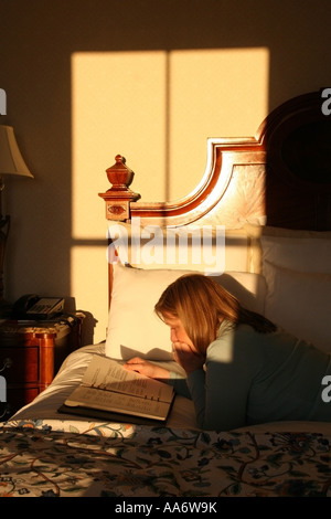 Reading the Hotel Directory in bed Stock Photo