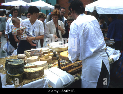 People check out  the cheese stand at a Farmers Market in Temple Bar Dublin Ireland Stock Photo