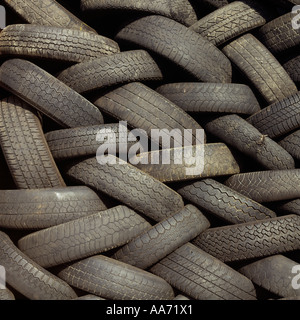 Rubber motor vehicle tyres stacked at a waste transfer station before being recycled Stock Photo