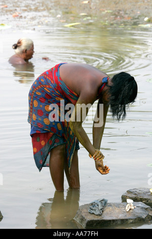 Women bathing at Bolgarh village, Orissa, India Stock Photo