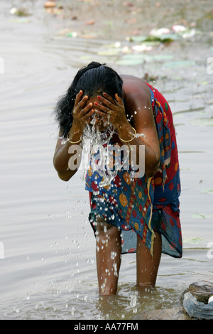 Woman bathing at Bolgarh village, Orissa, India Stock Photo