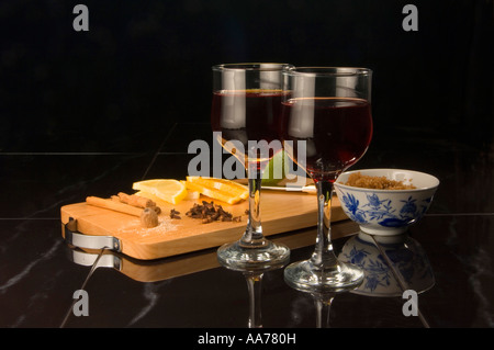 Glasses of mulled wine with the ingredients to make it Stock Photo