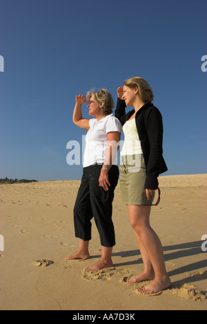 Two women scan the horizon. Stock Photo