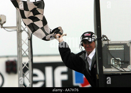 chequered flag being waved at the end of a motor race event Stock Photo