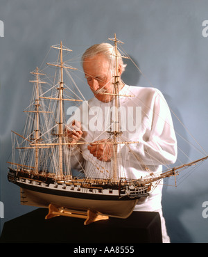 Senior citizen building a ship model Stock Photo