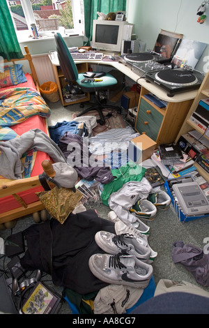 Boys bedroom in a very messy condition with cloths and rubbish strewn on the floor Stock Photo