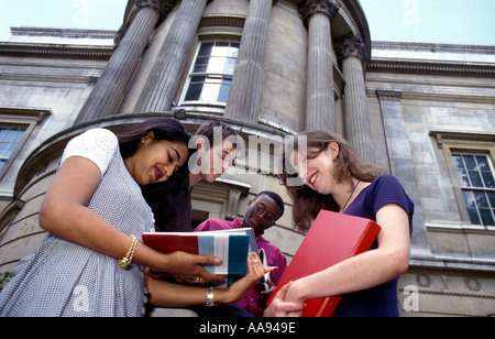 Group of university students standing chatting outside on campus. Stock Photo