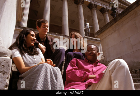 Multiracial student group chatting  on campus. Stock Photo