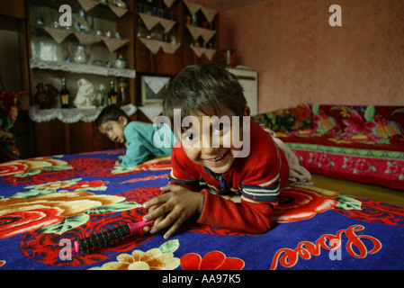 TWO ROMA GYPSY CHILDREN IN A HOUSE ON A SITE NEAR KOSICE IN SLOVAKIA Stock Photo