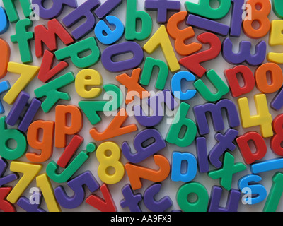 Magnetic letters and numbers on a fridge. Stock Photo