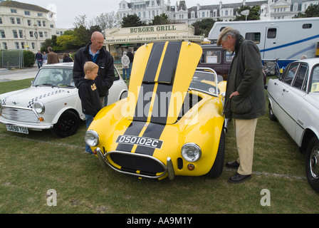 Looking at cars at Magnificent Motors, an annual car show in Eastbourne on the south coast of England. Stock Photo