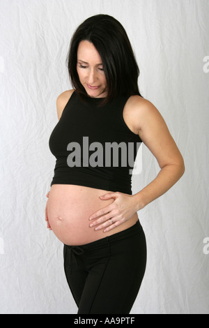 Pregnant Woman Wearing a Black Vest Top and Black Trousers