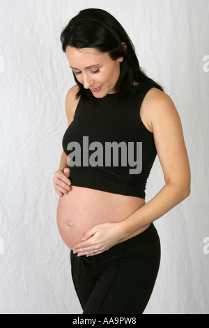 Pregnant Woman Wearing a Black Vest Top and Black Trousers