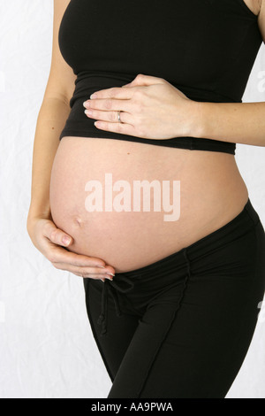 Pregnant Woman Wearing a Black Top and Trousers