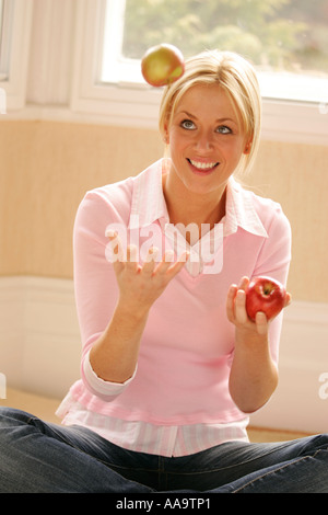 Girl juggling apples Stock Photo