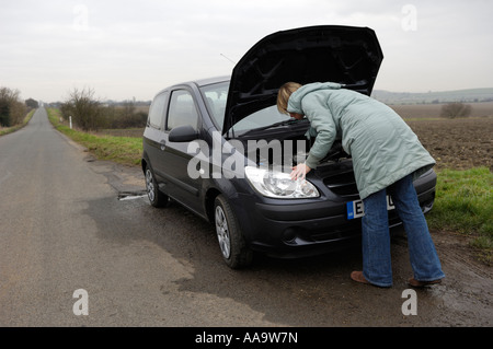 Woman with broken down car, UK Stock Photo