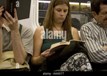 Lexington Avenue IRT NYC Passengers reading as they ride the subway in ...