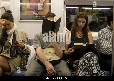 Lexington Avenue IRT NYC Passengers reading as they ride the subway in ...