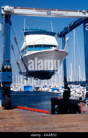 Power boat in dry dock lifted by crane Stock Photo