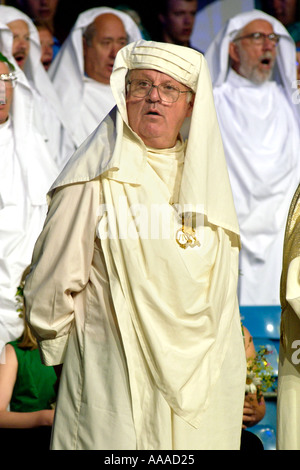 Gorsedd of Bards sing Welsh National Anthem at a Ceremony on stage at the National Eisteddfod St Davids Pembrokeshire Wales UK Stock Photo