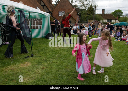 Two young girls dancing to Glam Rock band The Look, playing at the South Stoke, Berkshire, May 1st village fair England. Stock Photo