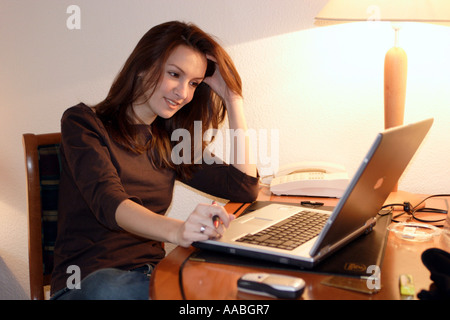 woman with notebook in a hotel room Stock Photo