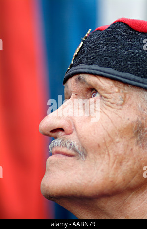 Bosnian Serb from the Republika Srpska Wearing Traditional Serbian Chetnik Headdress With the Serb Flag in the Background Stock Photo