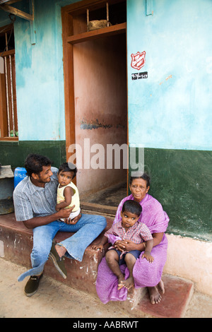India Tamil Nadu Kanyakumari Cape Comorin An Indian family sitting on the steps to their new home after the tsunami Stock Photo