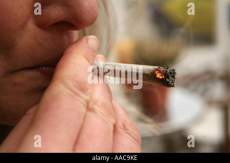 young woman smoking marijuana in a coffee shop in holland Stock Photo