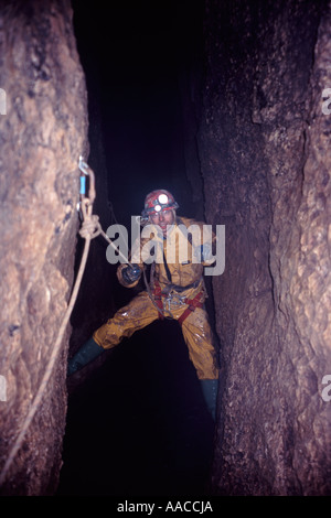Guide Rope Cave A caver uses single rope techniques to descend a pitch in a huge river ...