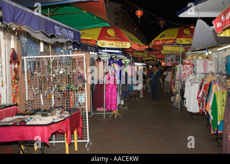 Busy shops and stalls on Pagoda Street selling colourful Chinese goods clothes and jewellery at night Chinatown Outram Singapore Stock Photo