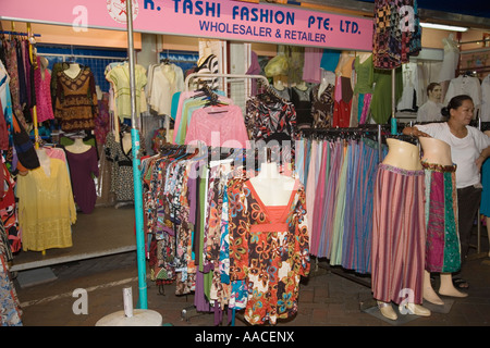 Shop on Pagoda Street selling colourful Chinese fashion clothing on display at night Chinatown Outram Singapore Stock Photo