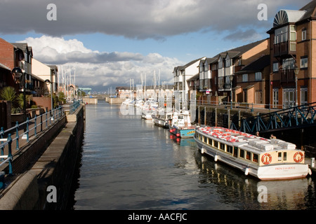 Boats moored in Penarth Marina looking east towards the Cardiff Barrage storm clouds threatening Stock Photo