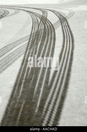 Skid tyre marks in a light layer of snow in Tunbridge Wells. Shot with a shallow depth of field, making the foreground out of focus. Stock Photo