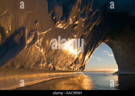 Greenland Ilulissat Setting midnight sun lights massive arched iceberg from Ilulissat Kangerlua Glacier Jakobshavn Icefjord floa Stock Photo