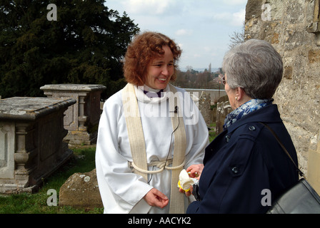 Revd Anne Le Bas greeting the congregation after the service Stock Photo