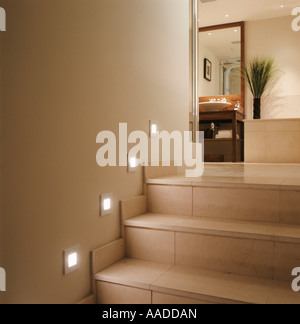 Spot lighting on tiled stairway to bathroom Stock Photo