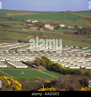 View over part of Camping and Caravan site at Croyde Bay from yellow gorse covered hill North Devon England Stock Photo