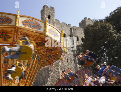 children on funfair ride in front of Rochester castle during the 2006 Sweeps Festival Stock Photo