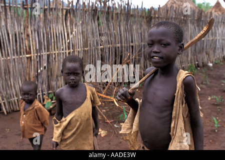 Young Dinka boy a Sudanese refugee boy naked getting mud filled water