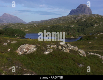 Suilven with lochan island and reeds in foreground Wester Ross North West Highlands of Scotland on a beautiful sunny summer day Stock Photo