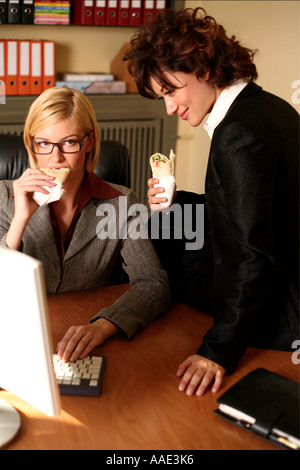 Two women working at the computer Stock Photo