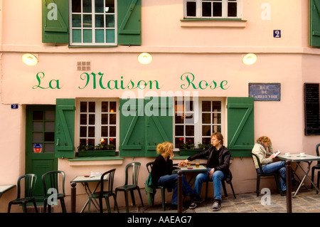 Young couple holding hands at a table outside La Maison Rose restaurant Montmatre Paris France Stock Photo