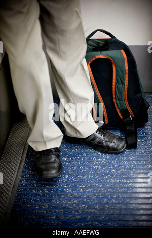 Man on tube train with rucksack Stock Photo