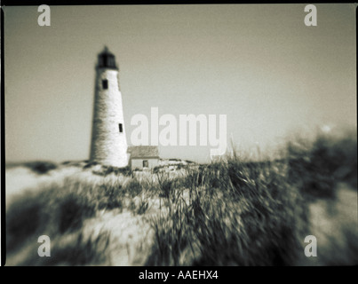 black & white shot of lighthouse on beach Stock Photo