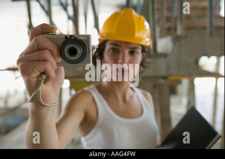 Female civil engineering surveyor using compact digital camera Stock Photo