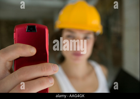 Female civil engineering surveryor using camera phone Stock Photo
